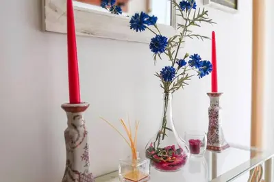 three vases on a table with blue flowers in them at Charming house in Rota + garden in Rota