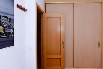 a wooden door in a room with a painting at Charming house in Rota + garden in Rota