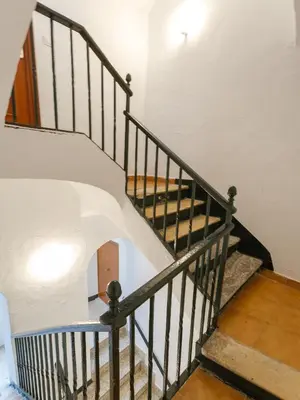 a spiral staircase in a house with white walls at SAIL Family Home by Cadiz4Rentals in Cádiz