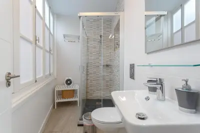 a white bathroom with a toilet and a sink at SAIL Family Home by Cadiz4Rentals in Cádiz