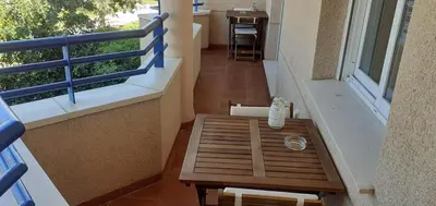 a balcony with a bench and a table on it at Apartamento acogedor en lugar inmejorable in Sanlúcar de Barrameda