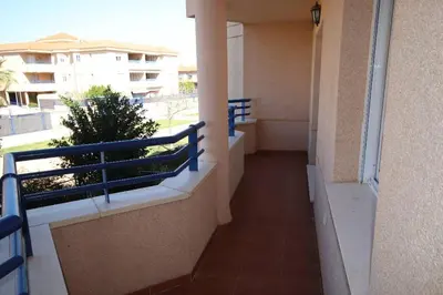 a balcony of a building with a blue railing at Apartamento acogedor en lugar inmejorable in Sanlúcar de Barrameda