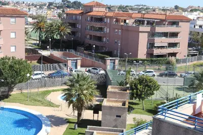 a resort with a pool and a parking lot at Apartamento acogedor en lugar inmejorable in Sanlúcar de Barrameda