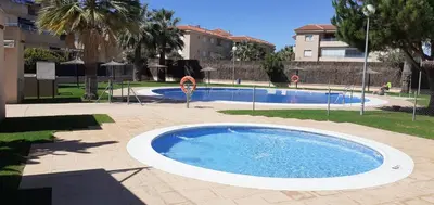 a large swimming pool in a yard with at Apartamento acogedor en lugar inmejorable in Sanlúcar de Barrameda