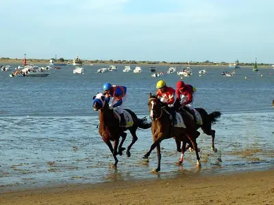 a group of people riding horses on the beach at Apartamento acogedor en lugar inmejorable in Sanlúcar de Barrameda