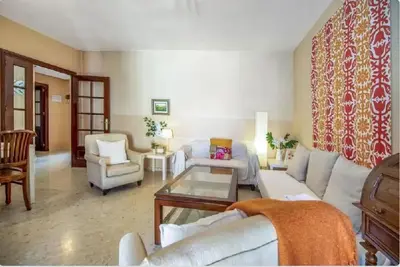 a living room with couches and chairs and a table at Charming apartment in El Puerto de Santa María with terrace in El Puerto de Santa María