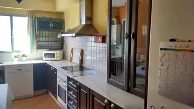 a kitchen with a stove and a refrigerator at Charming apartment in El Puerto de Santa María with terrace in El Puerto de Santa María