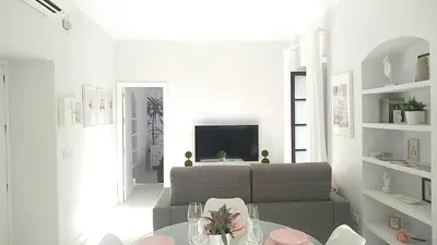 a living room with a couch and a table at Sherryflat San Agustín in Jerez de la Frontera