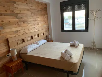 a bedroom with a bed with two towels on it at Apartamento Aqua Vitae in Cádiz