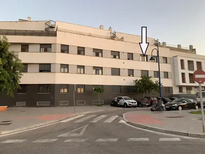 a large building with cars parked in front of it at Apartamento Aqua Vitae in Cádiz