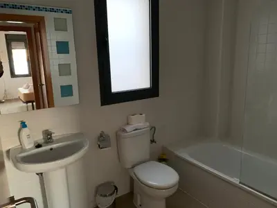 a bathroom with a toilet and a sink and a tub at Apartamento Aqua Vitae in Cádiz