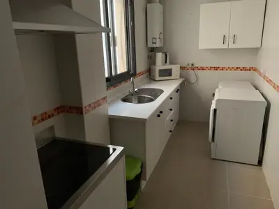 a small kitchen with a sink and a refrigerator at Apartamento Aqua Vitae in Cádiz