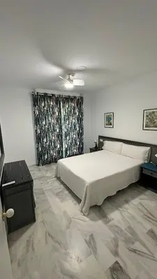 a bedroom with a large white bed and a window at Castillo del Espiritu Santo (La Jara) in Sanlúcar de Barrameda