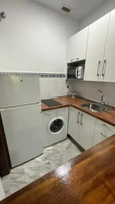 a kitchen with a sink and a washing machine at Castillo del Espiritu Santo (La Jara) in Sanlúcar de Barrameda