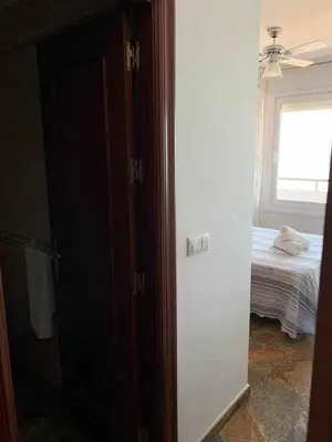 a room with a bedroom with a bed and a window at El Mirador de la Playa Cortadura Grupo AC Gestion in Cádiz