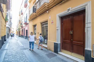 two people standing on a street near a building at Apartment Cadiz´s Angel in Cádiz