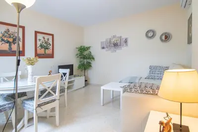 a living room with a table and a dining room at Apartment Cadiz´s Angel in Cádiz