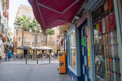 a street in a city with people walking down the street at Apartment Cadiz´s Angel in Cádiz