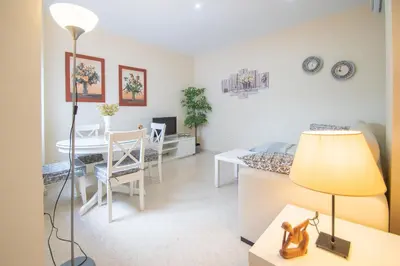 a living room with a bed and a table at Apartment Cadiz´s Angel in Cádiz