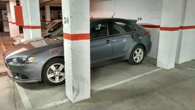 a car parked in a parking lot in a garage at Los luceros in Rota