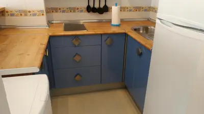 a kitchen with blue cabinets and a sink at Los luceros in Rota