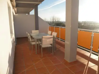 a balcony with a table and chairs on it at Apartamento Costa Ballena in Chipiona