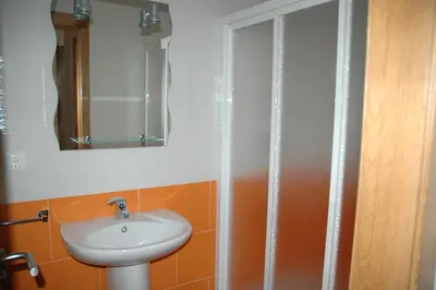 a bathroom with a sink and a mirror at Apartamento Costa Ballena in Chipiona