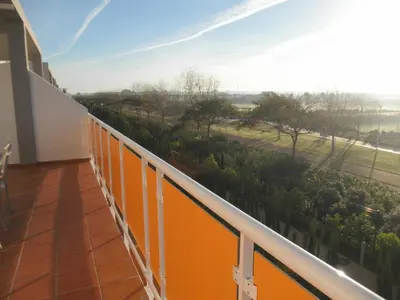 a balcony with a view of a garden at Apartamento Costa Ballena in Chipiona