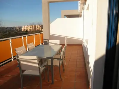 a balcony with a table and chairs on it at Apartamento Costa Ballena in Chipiona