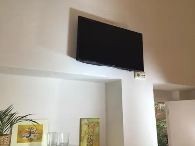 a flat screen tv hanging on a wall at Santo Domingo - Centro in Sanlúcar de Barrameda
