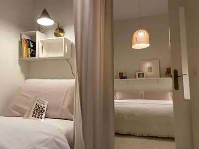 a bedroom with two twin beds and a mirror at Santo Domingo - Centro in Sanlúcar de Barrameda