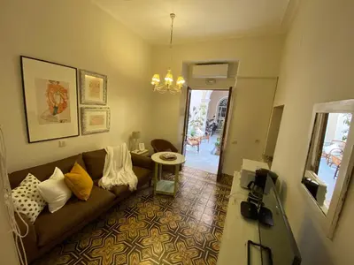 a living room with a couch and a table at Santo Domingo - Centro in Sanlúcar de Barrameda