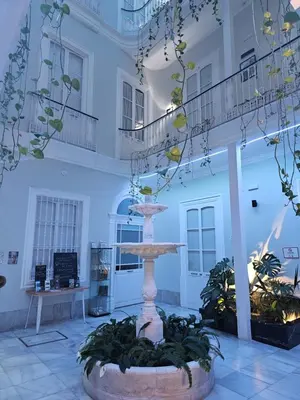 a fountain in the middle of a building at Planeta Cadiz Hostel in Cádiz