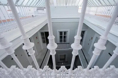 a staircase in a building with white railings at Planeta Cadiz Hostel in Cádiz