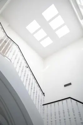 a white room with white ceilings and skylights at Planeta Cadiz Hostel in Cádiz