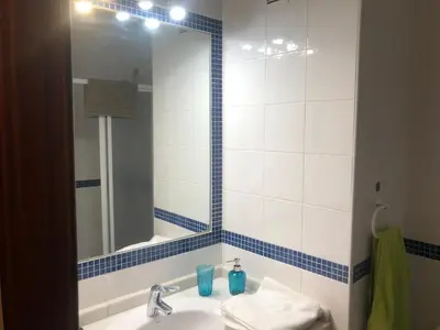 a bathroom with a sink and a mirror at PISO 1ª LINEA SANLUCAR DE BARRAMEDA in Sanlúcar de Barrameda