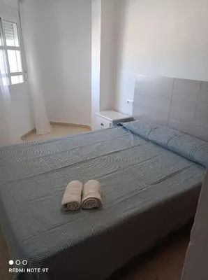 a bedroom with a bed with two towels on it at PISO 1ª LINEA SANLUCAR DE BARRAMEDA in Sanlúcar de Barrameda