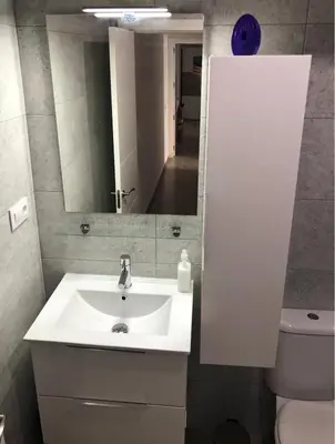 a bathroom with a sink and a mirror and a toilet at Apartamento Gran Teatro Falla-La Caleta in Cádiz