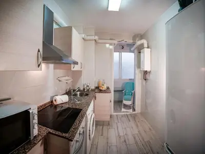 a kitchen with a sink and a counter top at Sirenas Playa Ha Apartment in Cádiz