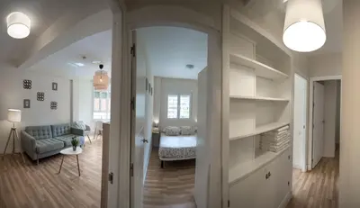 a living room with a couch and a chair in a room at Sirenas Playa Ha Apartment in Cádiz