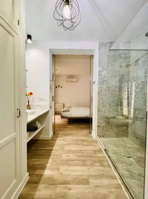 a bathroom with a walk in shower and a sink and a mirror at Chipibeach B&B, Hostal Boutique in Chipiona