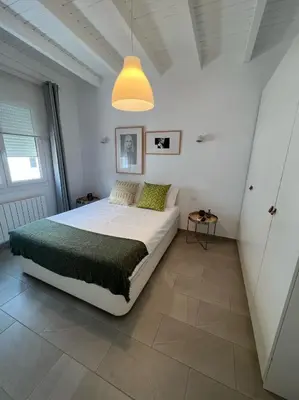 a bedroom with a bed and a pendant light at Chipibeach B&B, Hostal Boutique in Chipiona
