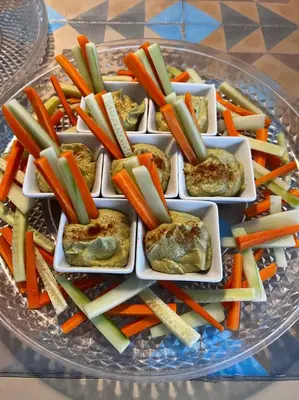 a tray of vegetables on a glass plate on a table at Chipibeach B&B, Hostal Boutique in Chipiona