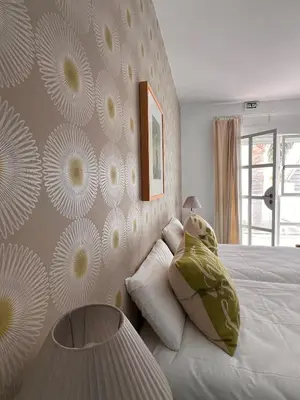 a bedroom with a bed and a table in it at Chipibeach B&B, Hostal Boutique in Chipiona