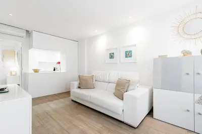 a white living room with a white couch at Casa Brasil - 1ª Linea Playa con Parking Incluido in Cádiz