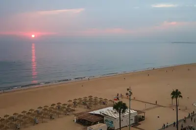 a view of a beach with umbrellas and the ocean at Casa Brasil - 1ª Linea Playa con Parking Incluido in Cádiz