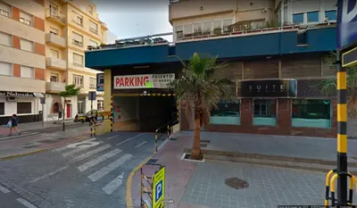 a building with a parking garage on a city street at Casa Brasil - 1ª Linea Playa con Parking Incluido in Cádiz