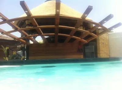 a wooden pavilion over a swimming pool at Villa Campito in El Puerto de Santa María