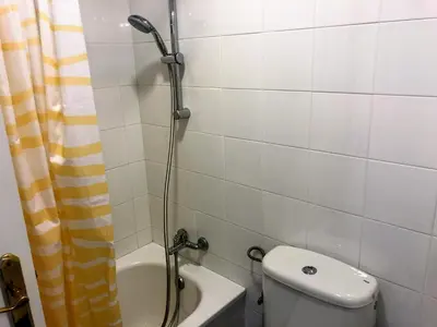 a bathroom with a shower with a toilet and a sink at Apartamento Zinna in Chiclana de la Frontera