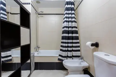 a small bathroom with a toilet and a bath tub at Puerta San FELIX free parking by Cadiz4Rentals in Cádiz